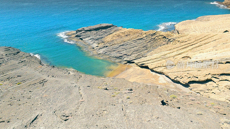 Aerial view of the hidden cove beach "Playa Cumplida" at the natural reserve of "Montaña Pelada" in Tenerife (Canary Islands). Drone shot